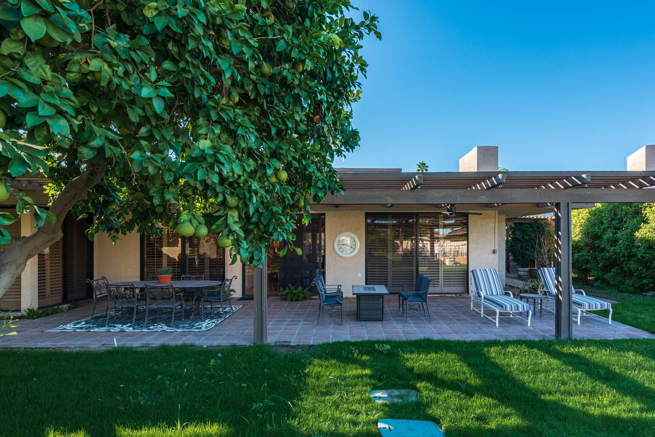 2 Lehigh Court Rancho Mirage, CA 92270 - Photo 37 of 43 a view of a patio with table and chairs potted plants and a large tree