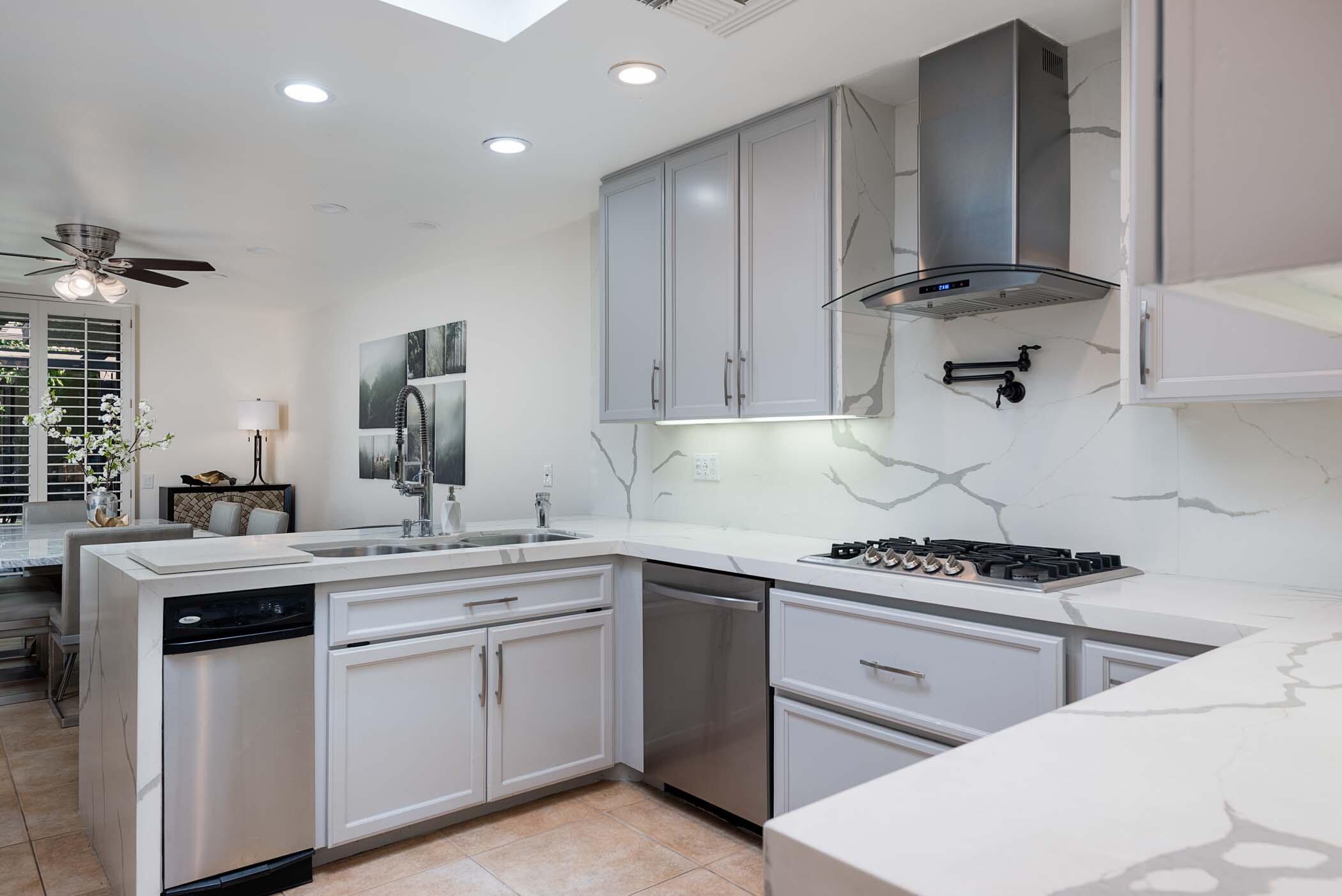 2 Lehigh Court Rancho Mirage, CA 92270 - Photo 4 of 43 a kitchen with a sink stove top oven and cabinets