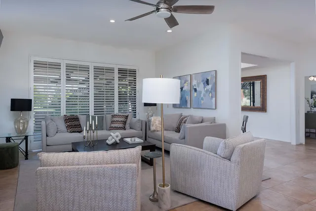 a view of a patio with a table and chairs and potted plants
