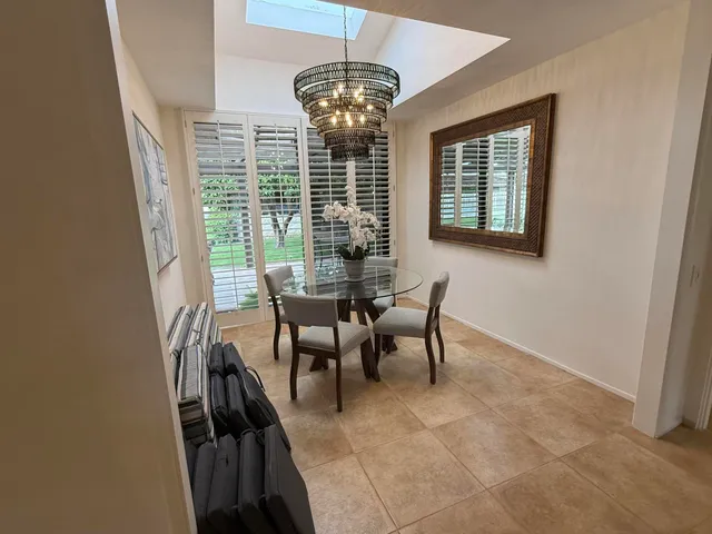 a dining room with furniture and window