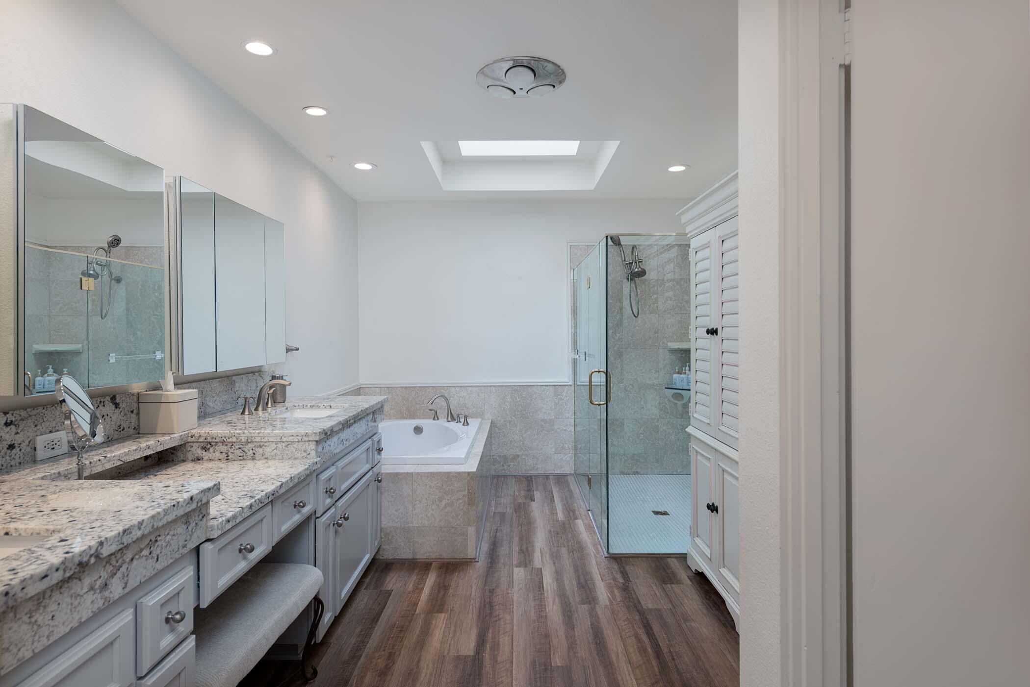 2 Lehigh Court Rancho Mirage, CA 92270 - Photo 8 of 43 a spacious bathroom with a granite countertop sink a mirror and a shower
