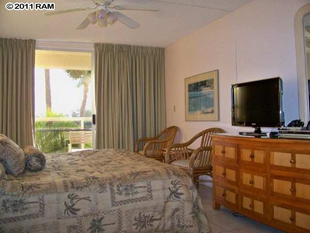 2575 South Kihei Road, Unit G307 Kihei, HI 96753 - Photo 14 of 25 a bedroom with a bed and a flat screen tv
