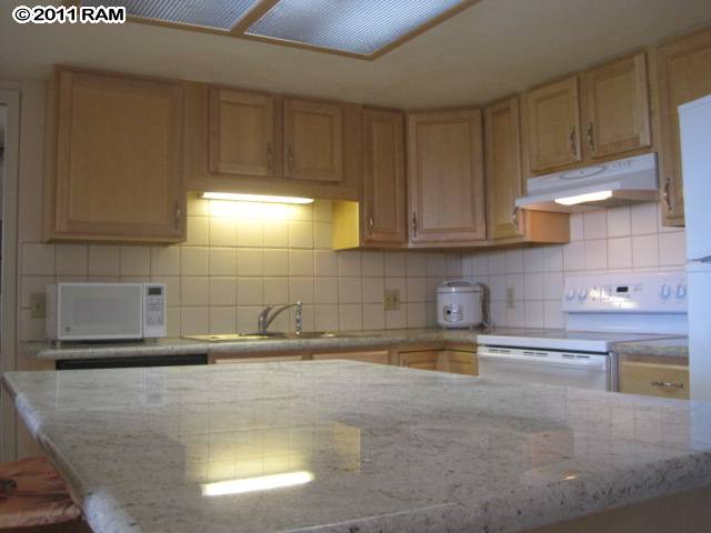 2575 South Kihei Road, Unit G307 Kihei, HI 96753 - Photo 4 of 25 a kitchen with a sink and cabinets
