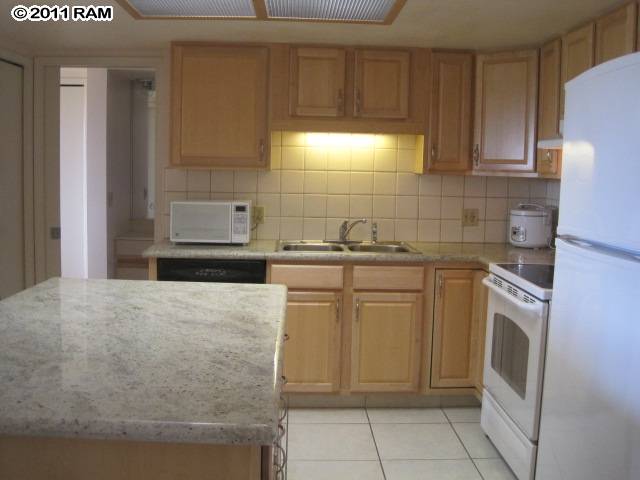 2575 South Kihei Road, Unit G307 Kihei, HI 96753 - Photo 6 of 25 a kitchen with a sink a stove and cabinets