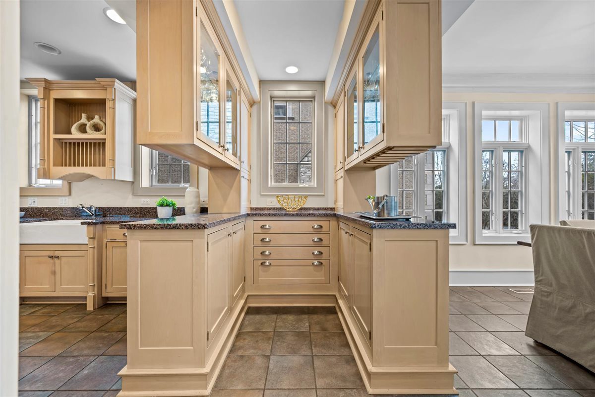 224 Sheridan Road Kenilworth, IL 60043 - Photo 20 of 62 a kitchen with white cabinets and white appliances