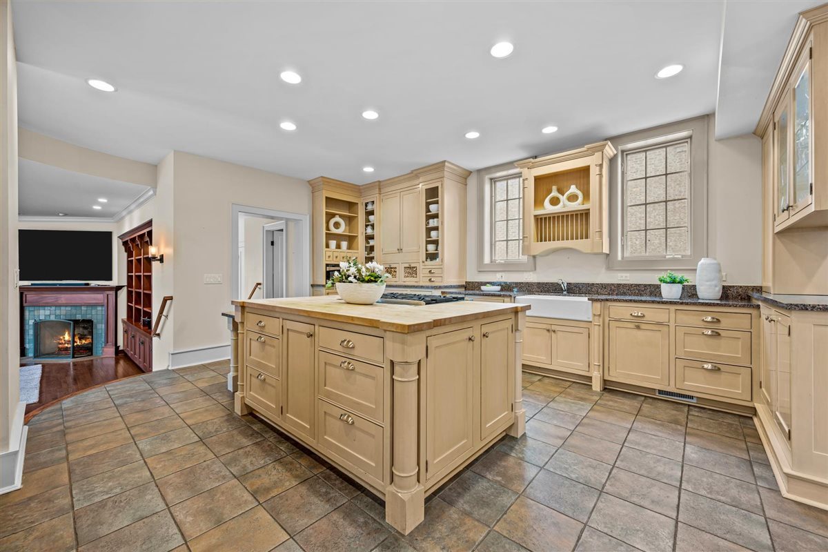 224 Sheridan Road Kenilworth, IL 60043 - Photo 22 of 62 a kitchen with stainless steel appliances kitchen island granite countertop a stove a sink and a refrigerator