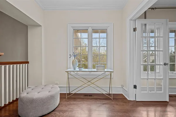 a living room with furniture and large windows