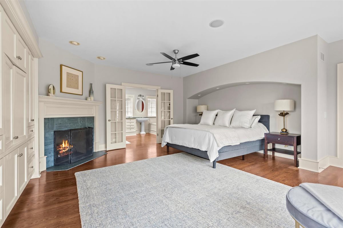 224 Sheridan Road Kenilworth, IL 60043 - Photo 33 of 62 a bedroom with a bed and a fireplace