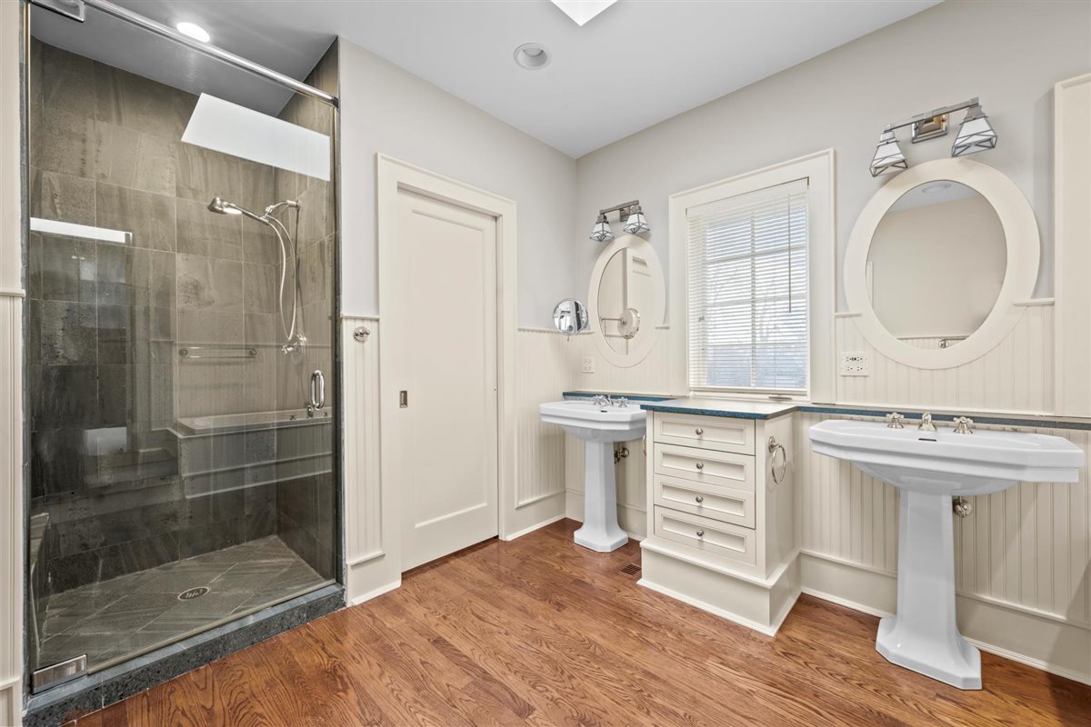 224 Sheridan Road Kenilworth, IL 60043 - Photo 37 of 62 a bathroom with a granite countertop sink mirror and shower