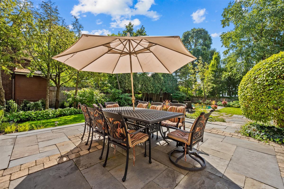 224 Sheridan Road Kenilworth, IL 60043 - Photo 55 of 62 a view of an outdoor sitting area with chairs and umbrella