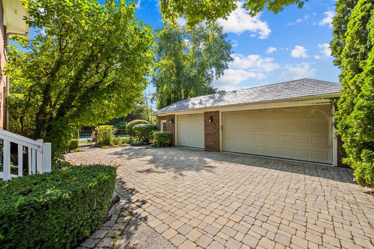 224 Sheridan Road Kenilworth, IL 60043 - Photo 56 of 62 a front view of a house with a yard and a garage
