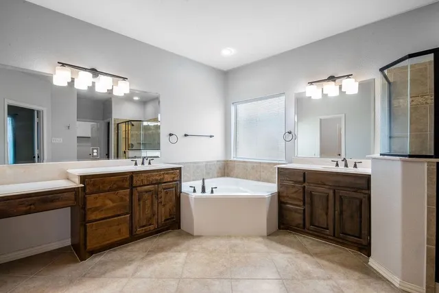 a large kitchen with stainless steel appliances kitchen island granite countertop a stove and a sink