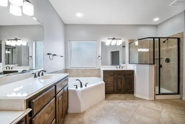 a view of kitchen with stainless steel appliances granite countertop stove top oven and cabinets