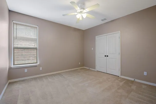 a spacious bathroom with a tub a double vanity sink and a mirror