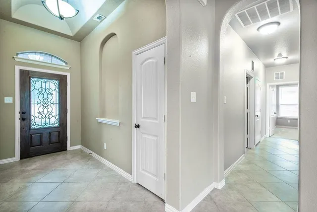 a view of a hallway with bathroom and shower