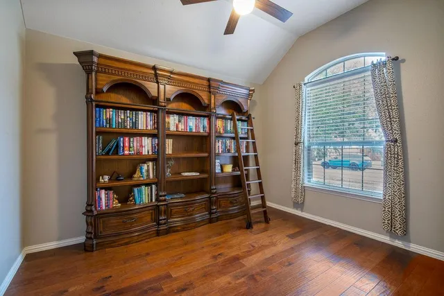 a view of room with book shelf and a window