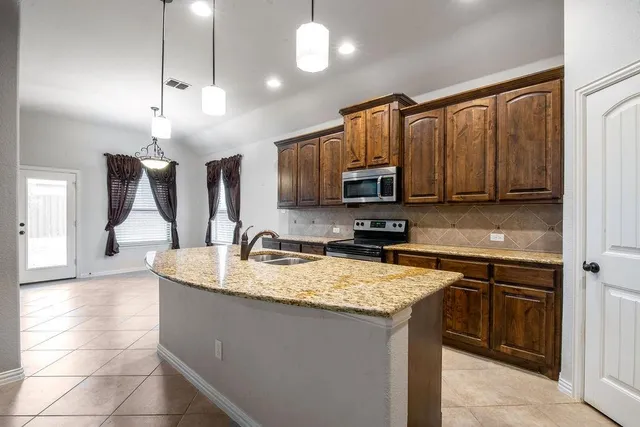 a kitchen with a sink stove and microwave