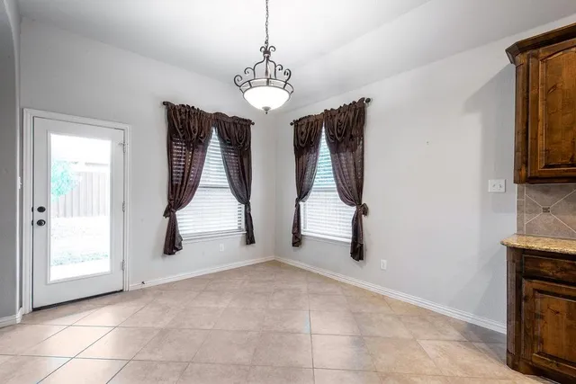 a view of a livingroom with furniture and staircase