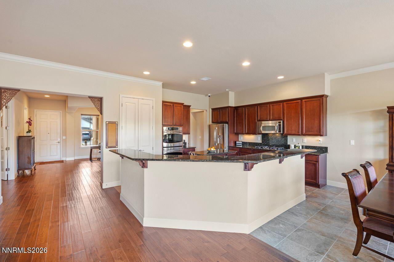 9325 Wrenwood Court Reno, NV 89523 - Photo 8 of 34 kitchen with bar and front door