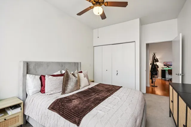 a bedroom with a bed and a chandelier