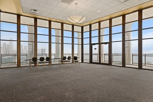 a view of an empty room with windows and a table