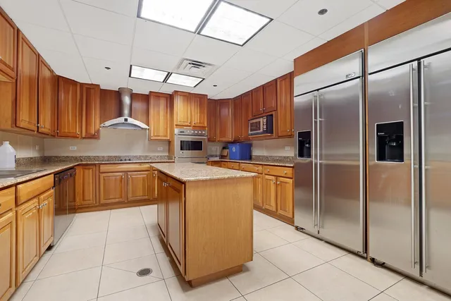 a kitchen with stainless steel appliances granite countertop a refrigerator a sink and dishwasher