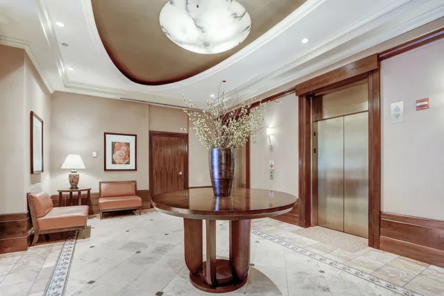 a lobby with furniture and mirror