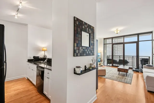 a kitchen with granite countertop a stove and white cabinets