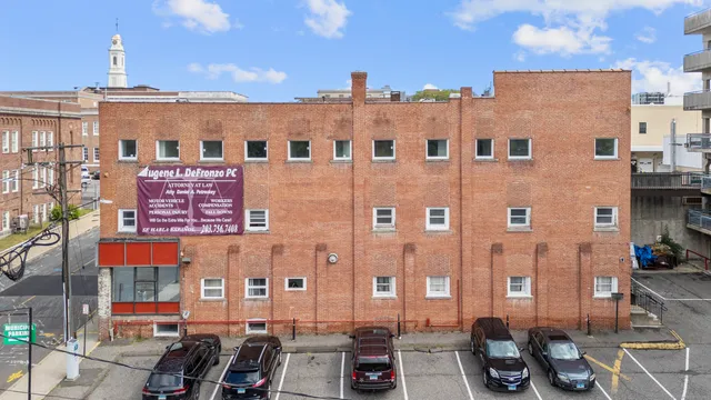 a view of a building with cars parked