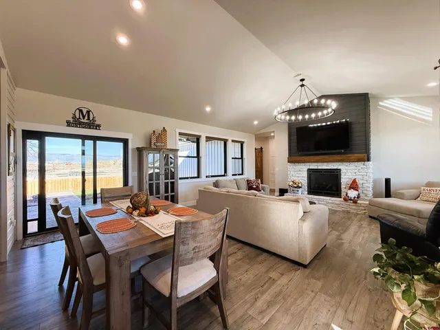 a living room with furniture a fireplace and a flat screen tv