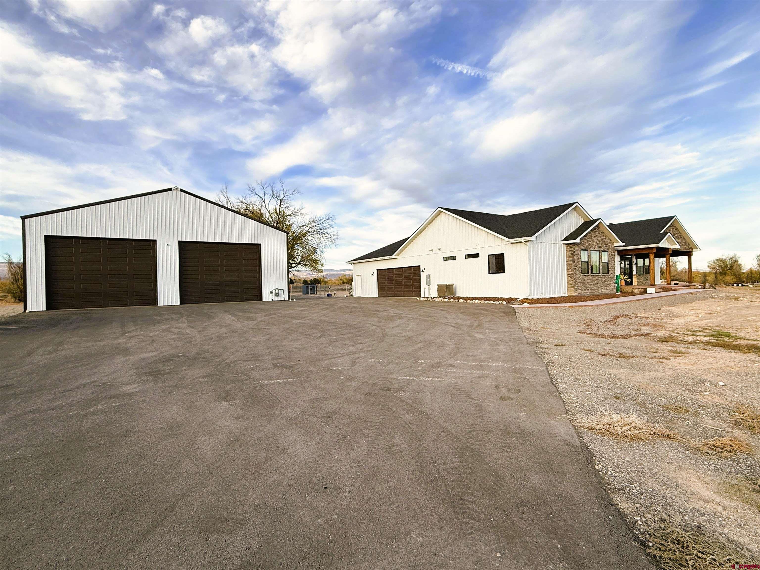 8585 Ellens Way Austin, CO 81410 - Photo 2 of 45 a view of a house with a big yard and large trees