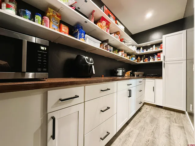 a kitchen with stainless steel appliances granite countertop a sink a stove and a wooden floors