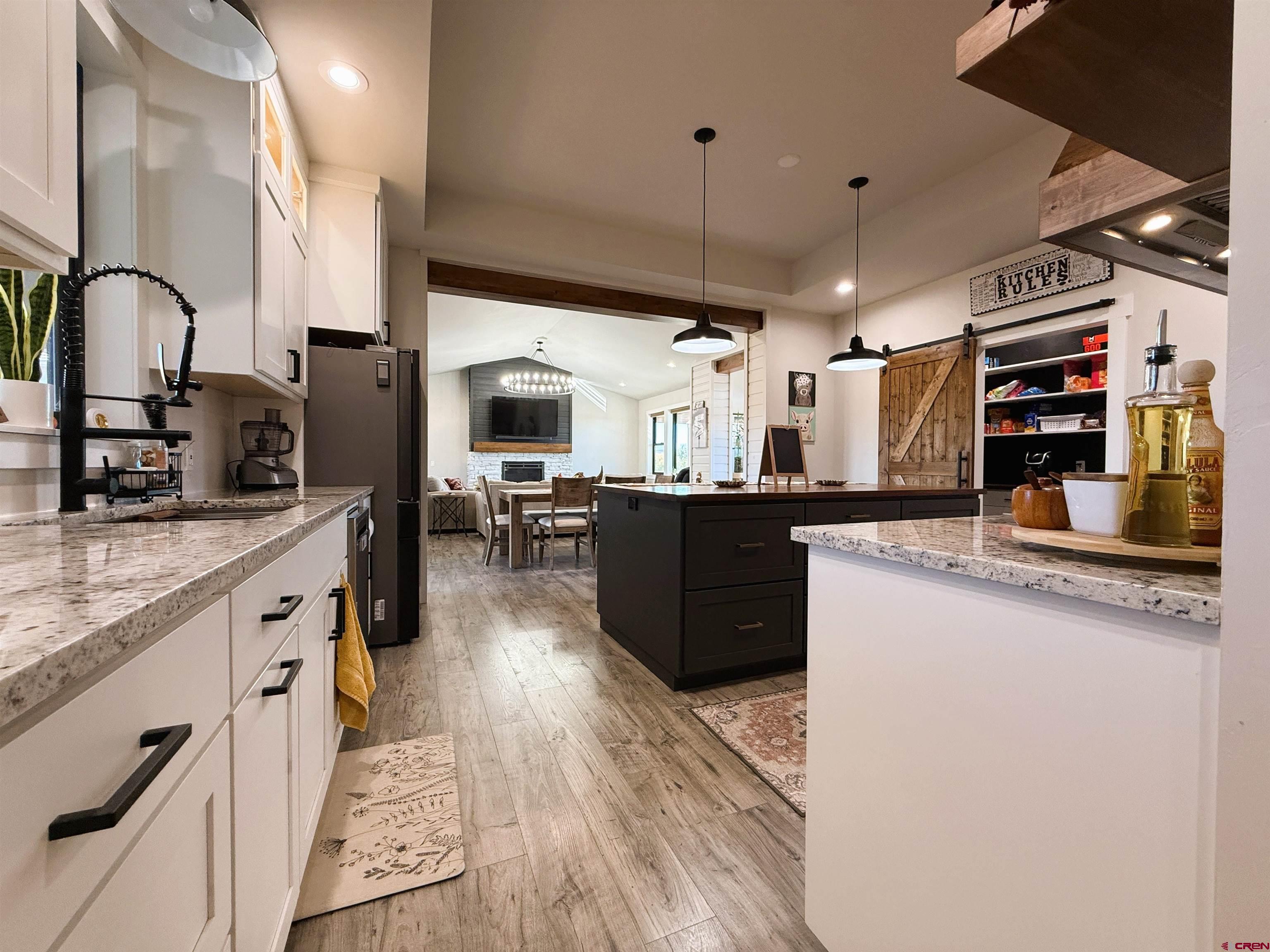8585 Ellens Way Austin, CO 81410 - Photo 24 of 45 a kitchen with stainless steel appliances kitchen island granite countertop a stove and a sink