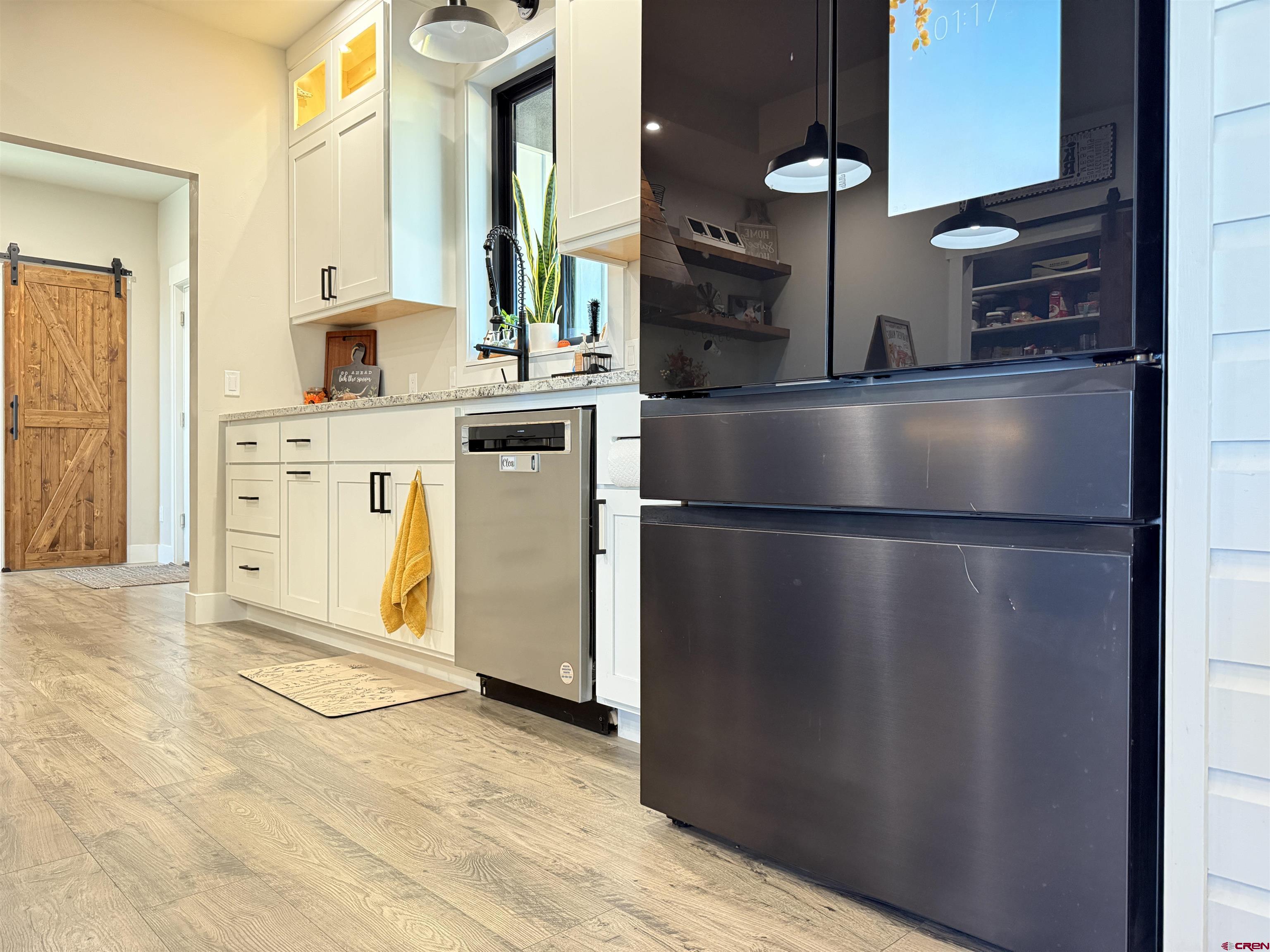 8585 Ellens Way Austin, CO 81410 - Photo 25 of 45 a kitchen with stainless steel appliances granite countertop a refrigerator a stove and a sink