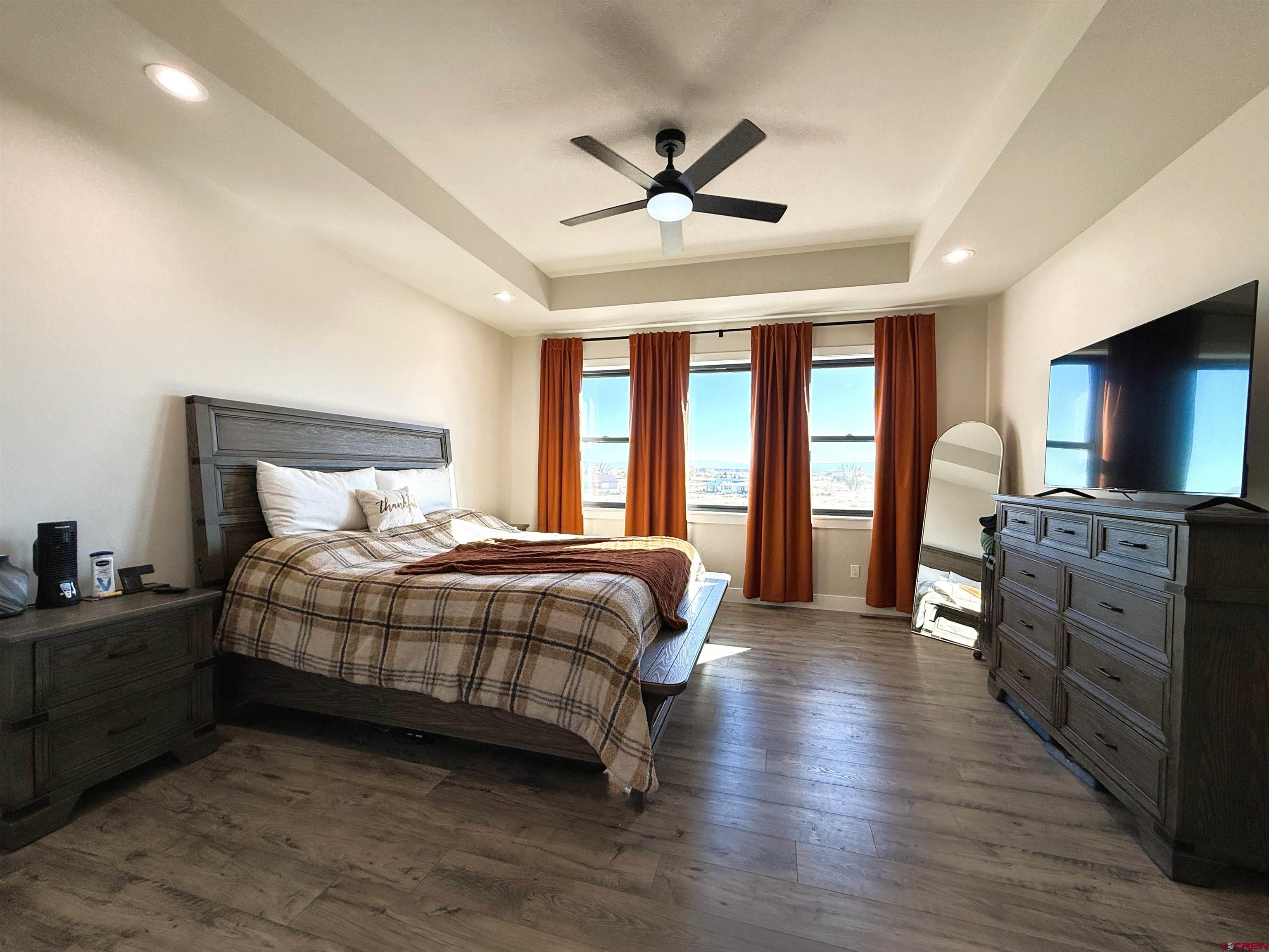 8585 Ellens Way Austin, CO 81410 - Photo 30 of 45 a bedroom with a bed and a flat screen tv