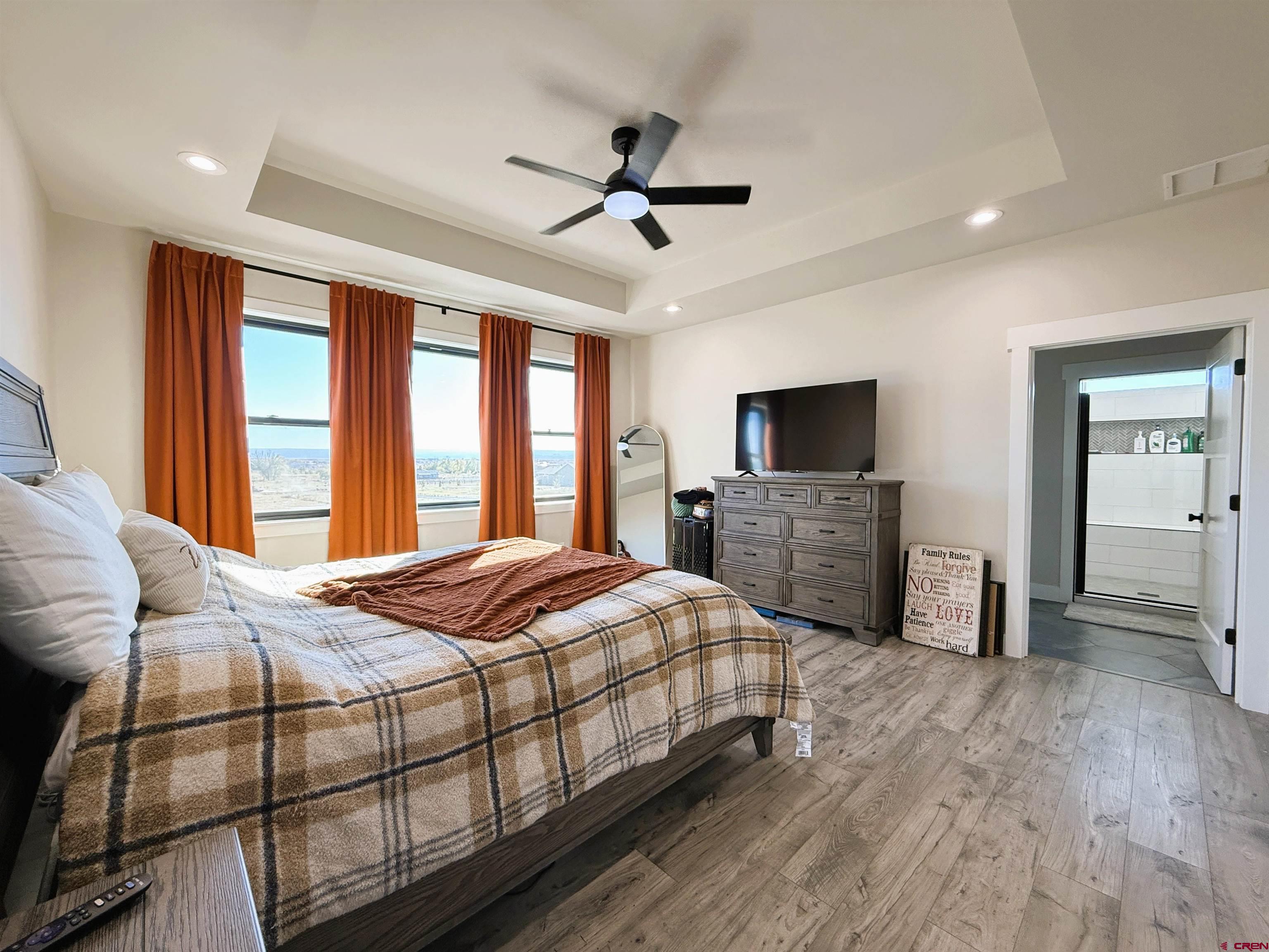 8585 Ellens Way Austin, CO 81410 - Photo 31 of 45 a bedroom with a bed and a flat screen tv