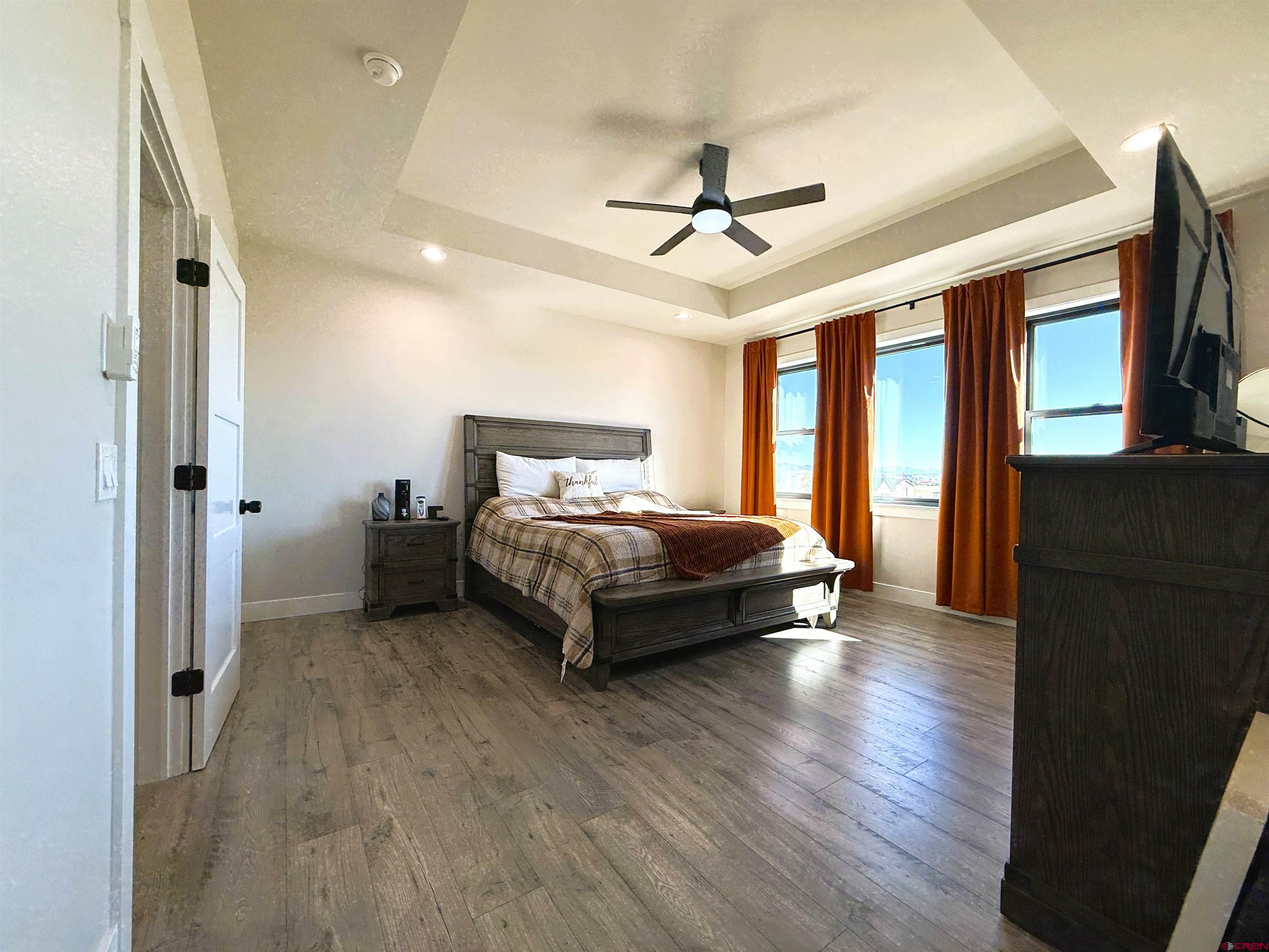 8585 Ellens Way Austin, CO 81410 - Photo 33 of 45 a bedroom with a bed and a chandelier