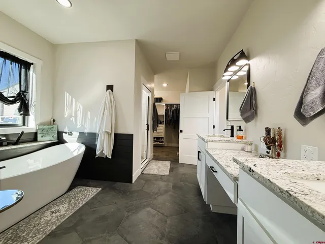 a living room with furniture and a painting on the wall