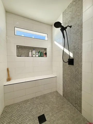 a bathroom with a double vanity sink mirror and bathtub