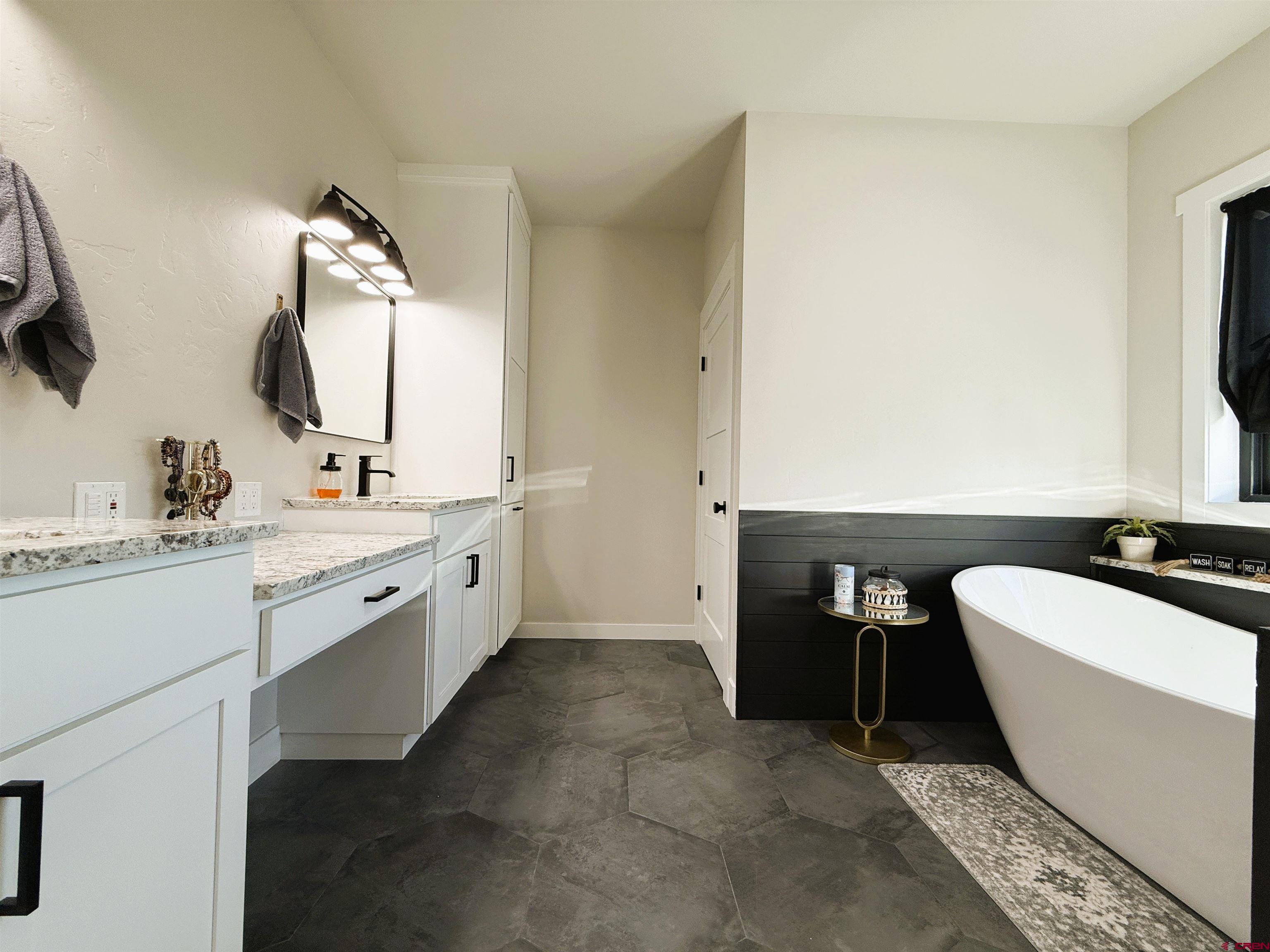 8585 Ellens Way Austin, CO 81410 - Photo 37 of 45 a bathroom with a double vanity sink mirror and bathtub
