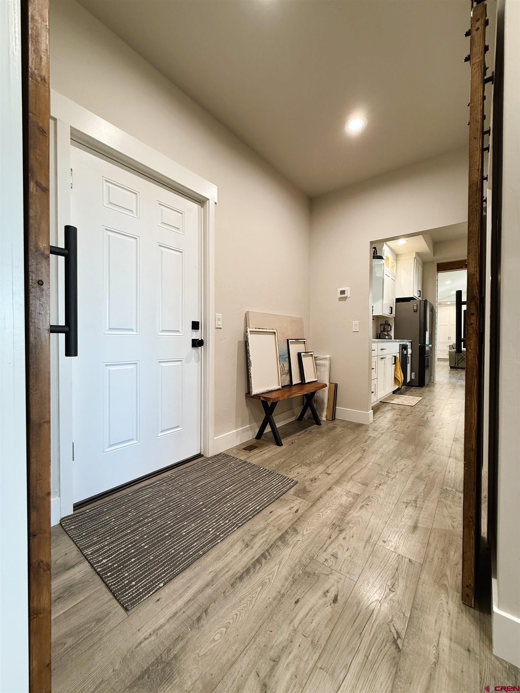 8585 Ellens Way Austin, CO 81410 - Photo 38 of 45 a view of a hallway with wooden floor and furniture