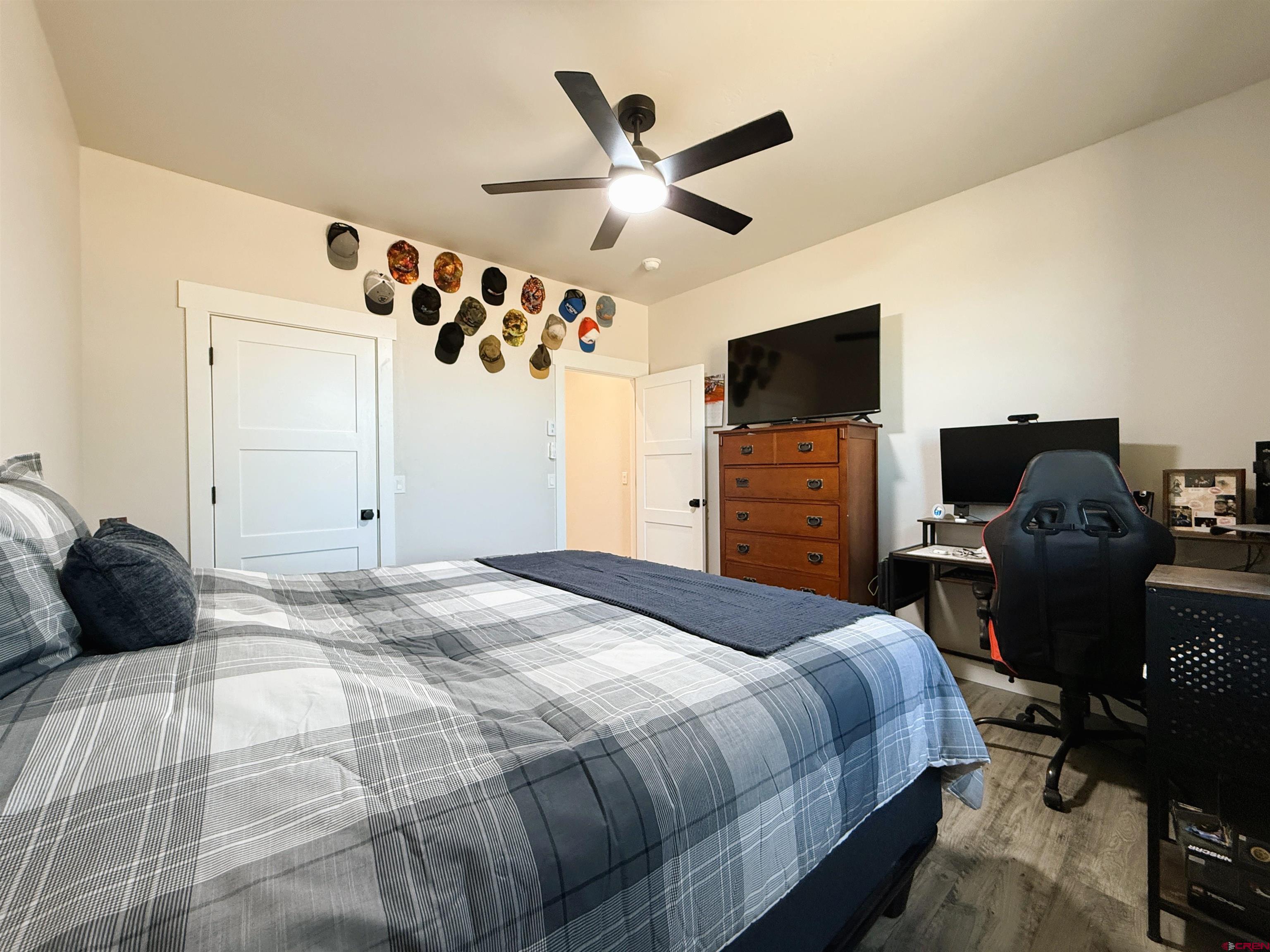 8585 Ellens Way Austin, CO 81410 - Photo 41 of 45 a bedroom with a bed and wooden floor