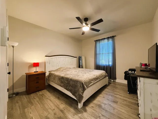 a spacious bedroom with a bed and a chandelier