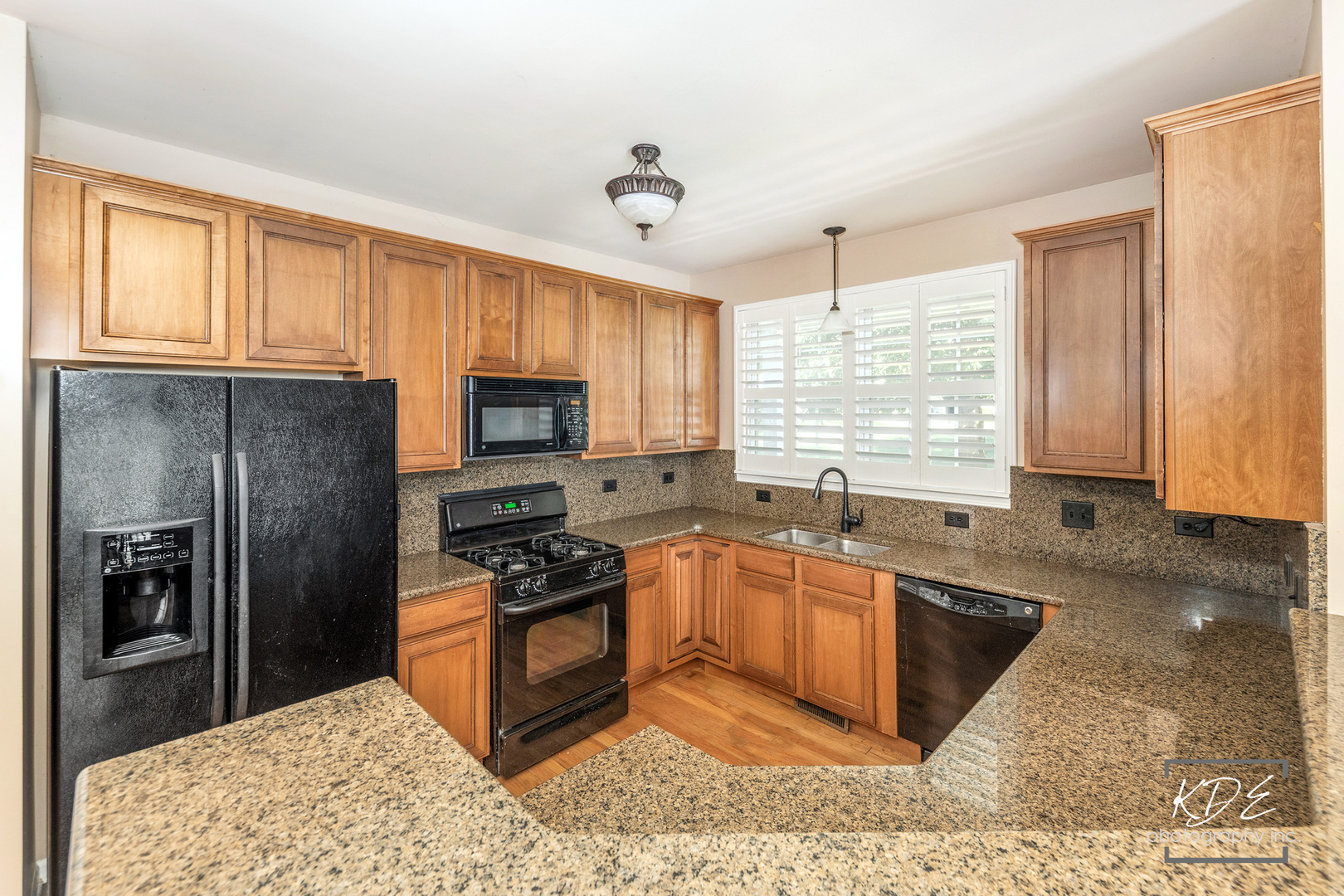 1022 Neudearborn Lane, Unit 191022 Naperville, IL 60563 - Photo 9 of 27 a kitchen with granite countertop a sink stove and refrigerator