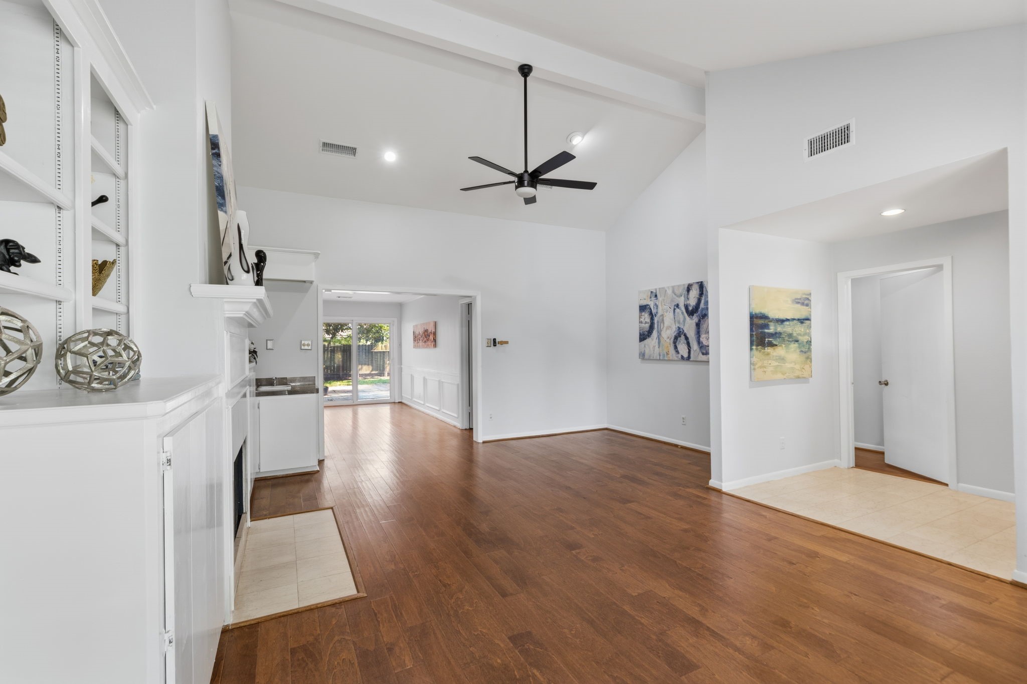 5410 Indigo Street Houston, TX 77096 - Photo 7 of 30 View from the living area with classic open flow to the dining areas all with gleaming floors and high ceilings.