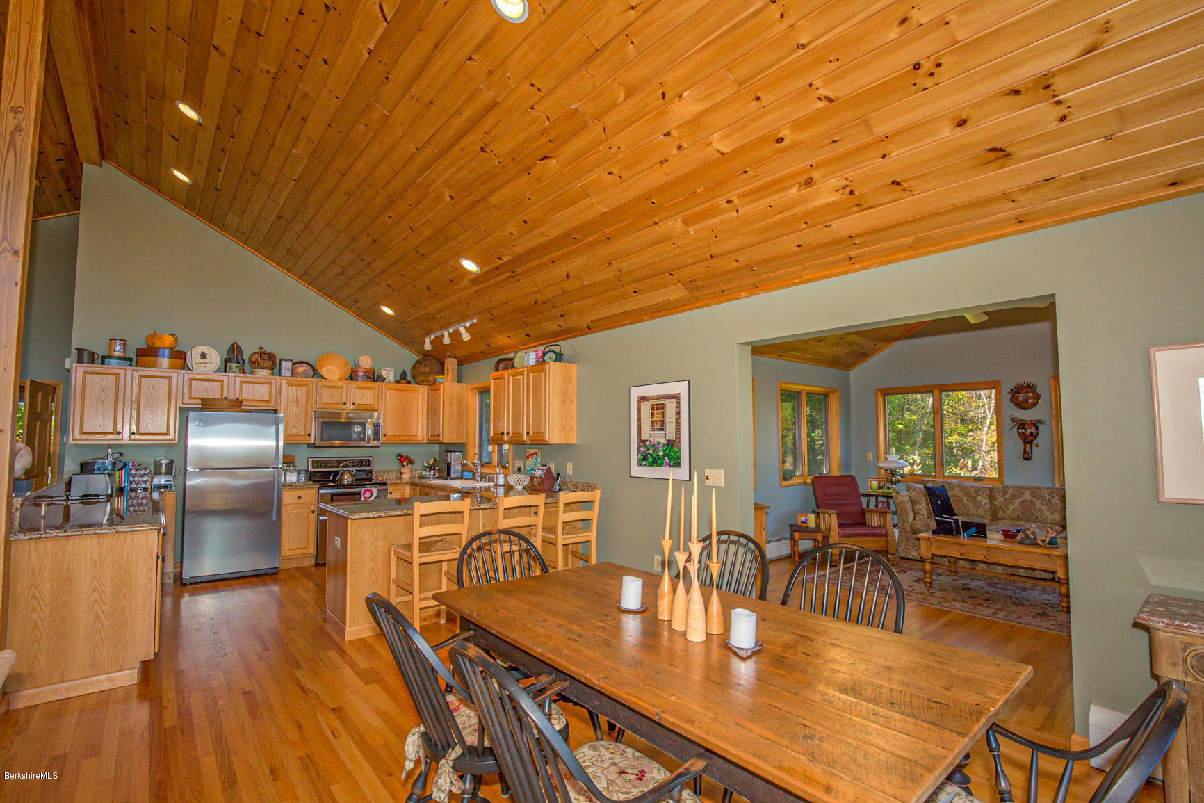 358 Harrington Road Otis, MA 01253 - Photo 7 of 52 a dining room with furniture a kitchen view and a wooden floor