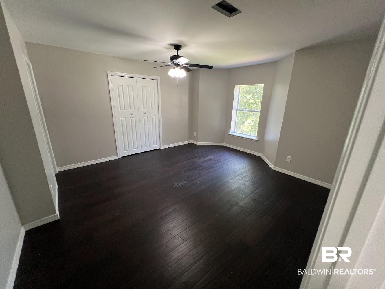 266 Ridgewood Drive Daphne, AL 36526 - Photo 21 of 34 Room featuring dark wood-finish flooring, light neutral-toned walls, and white baseboards