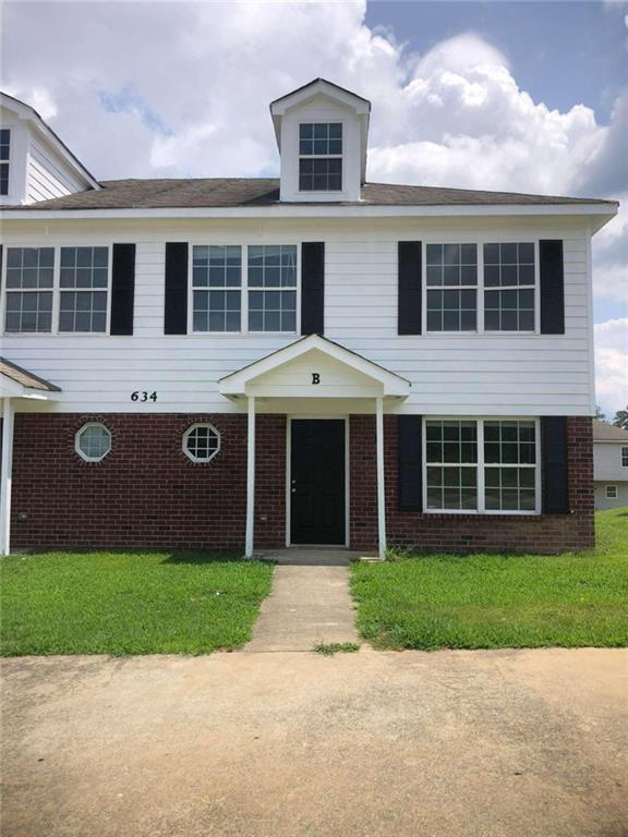 a view of front of house with a yard