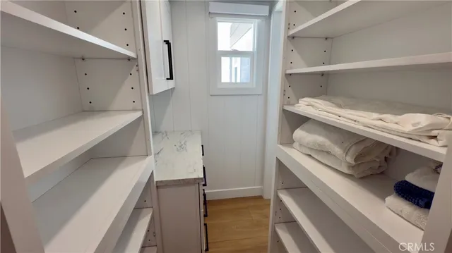 a storage room with a bed and a cabinets