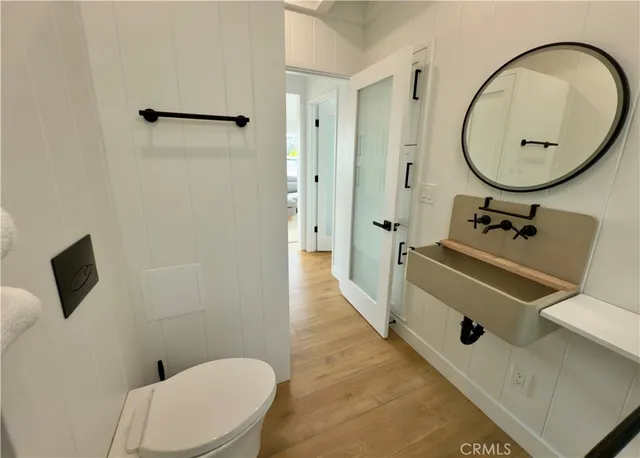 a bathroom with a sink mirror and toilet